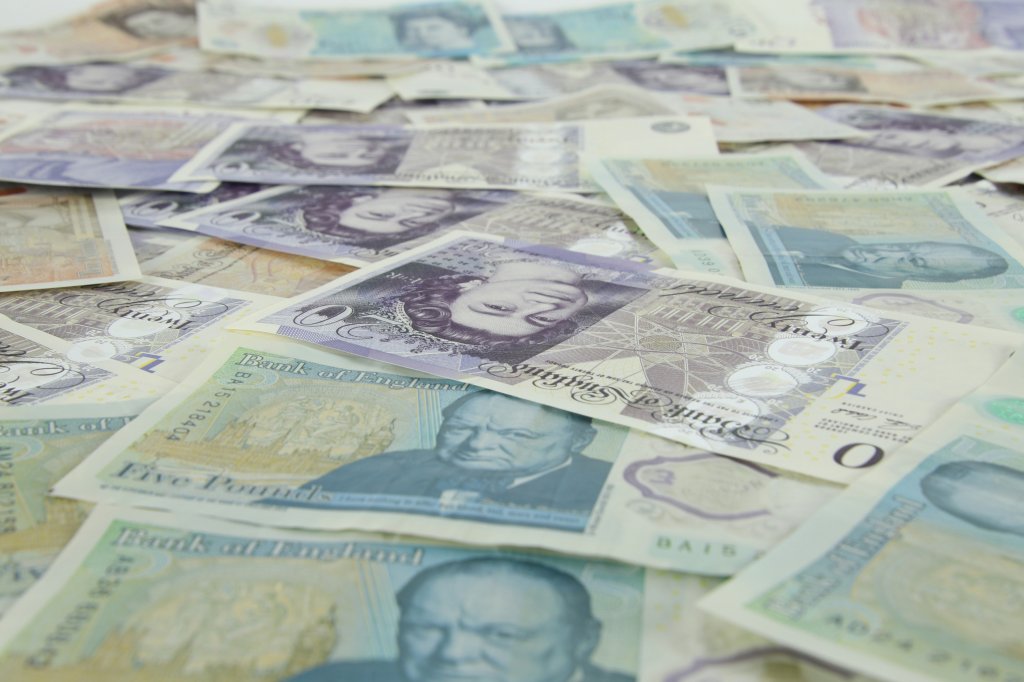 UK banknotes spread over an area.