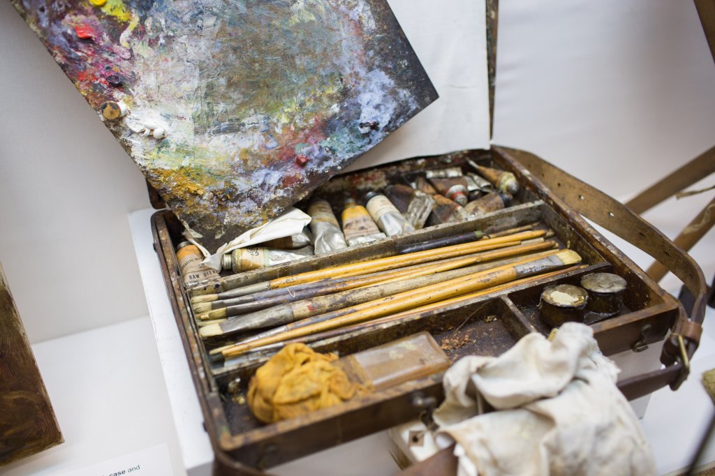 Old artists paint brushes and paint tubes.