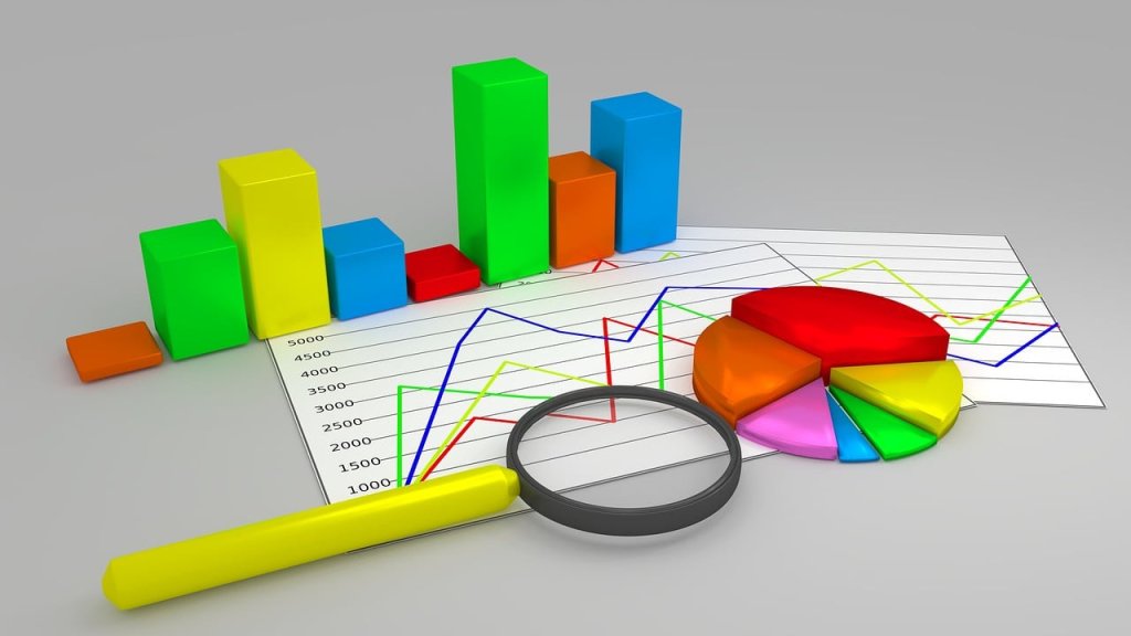 Magnifying glass with 2D line graph,3D graph blocks and a 3D pie chart.