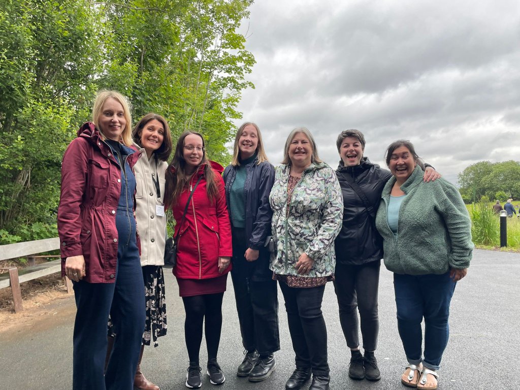 Seven members of the MDM team posing outside for a photo.